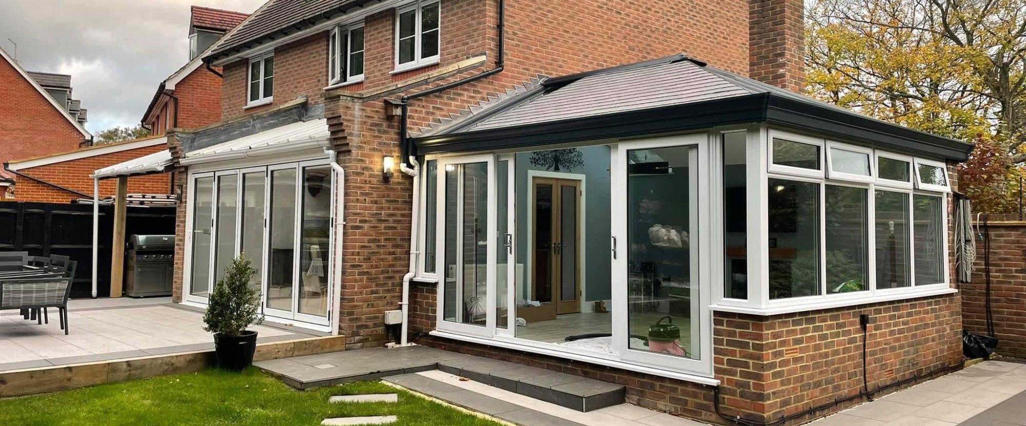 Image from outside showing a conservatory with a warm roof